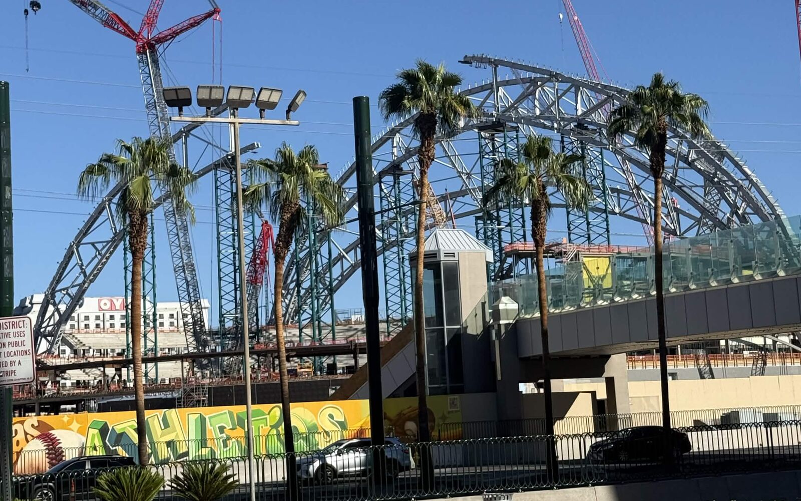 Las Vegas Athletics ballpark roof arch seen through palm trees from the Strip