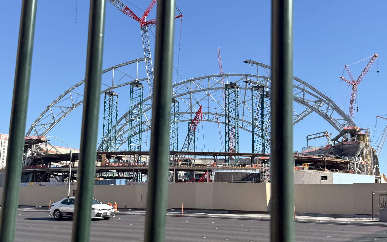Las Vegas Athletics ballpark construction seen through a metal fence along the Strip